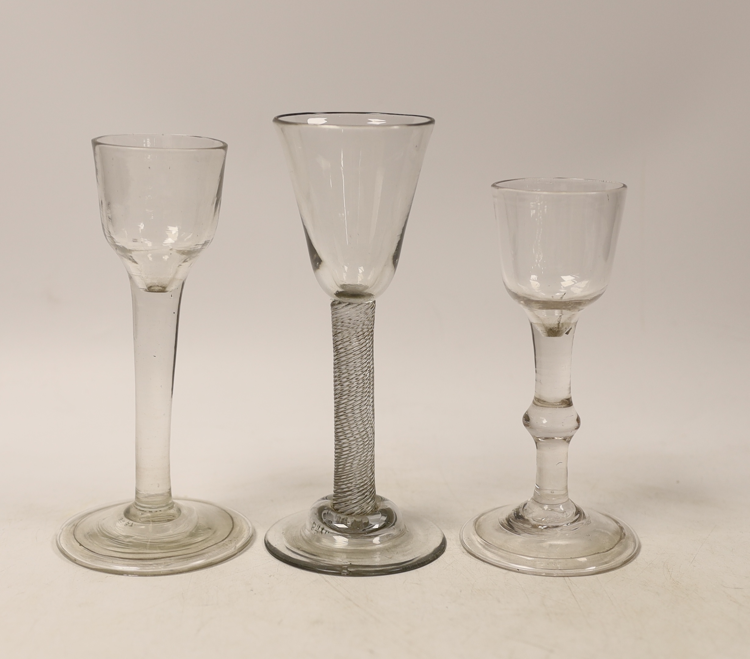 Three cordial glasses, first half 18th century, two with a folded foot, one with single knop and one with an incised twist stem, tallest 16cm